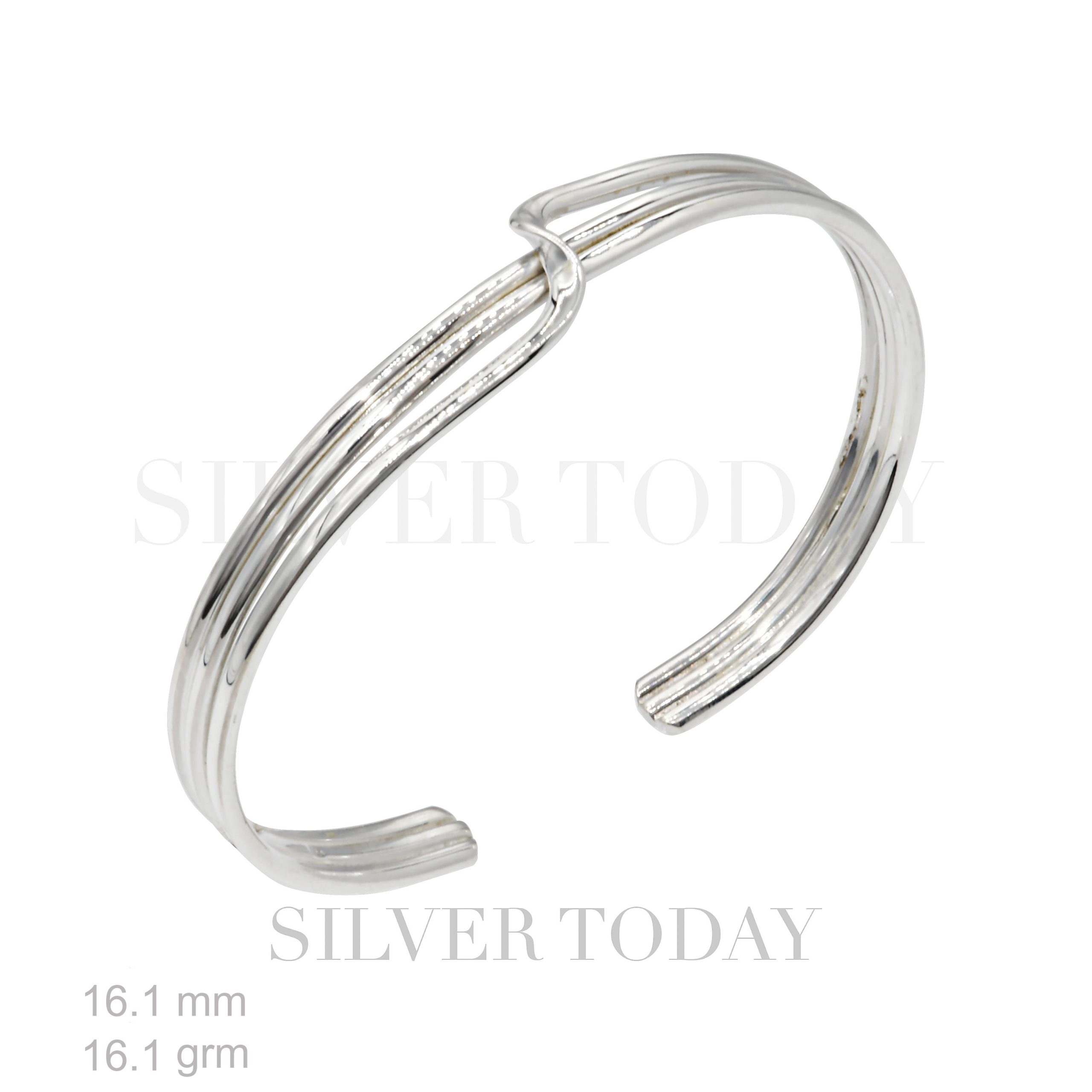 GCF090304 Silver cuff bracelet. The bracelet is open-ended and features a sleek, polished design with three parallel bands that are joined together and slightly twisted at the top center. The metal is shiny and reflective. In the background, faint text reads "SILVER TODAY." At the bottom left, there are specifications: "16.1 mm" and "16.1 grm," indicating the width and weight of the bracelet. The overall look is modern and elegant.